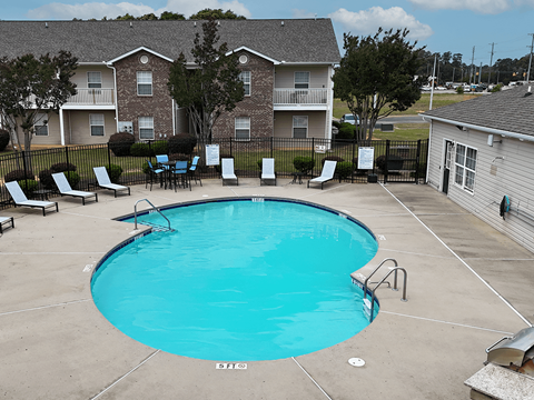 A small pool with a metal fence around it.