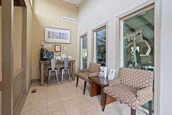 a living room with two chairs and a table