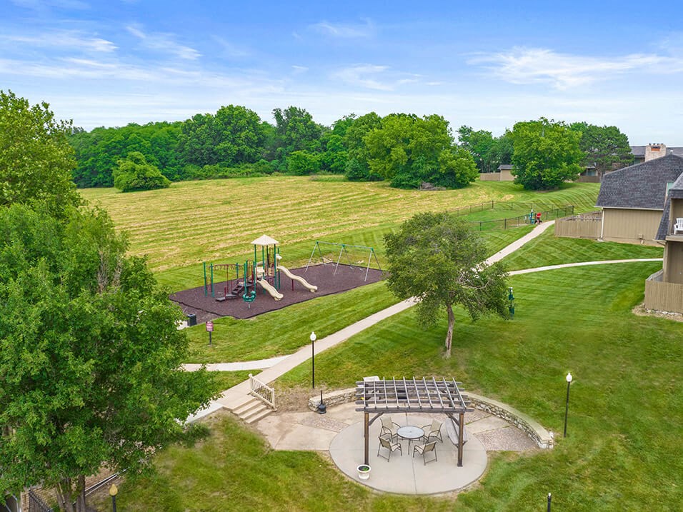 a rendering of a park with trees and a playground