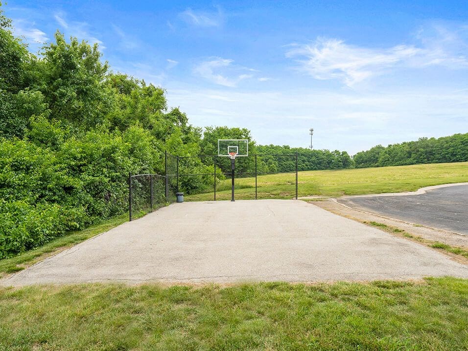a basketball court in the middle of a field
