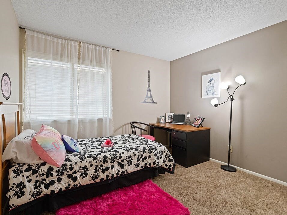 a bedroom with a bed and a dresser