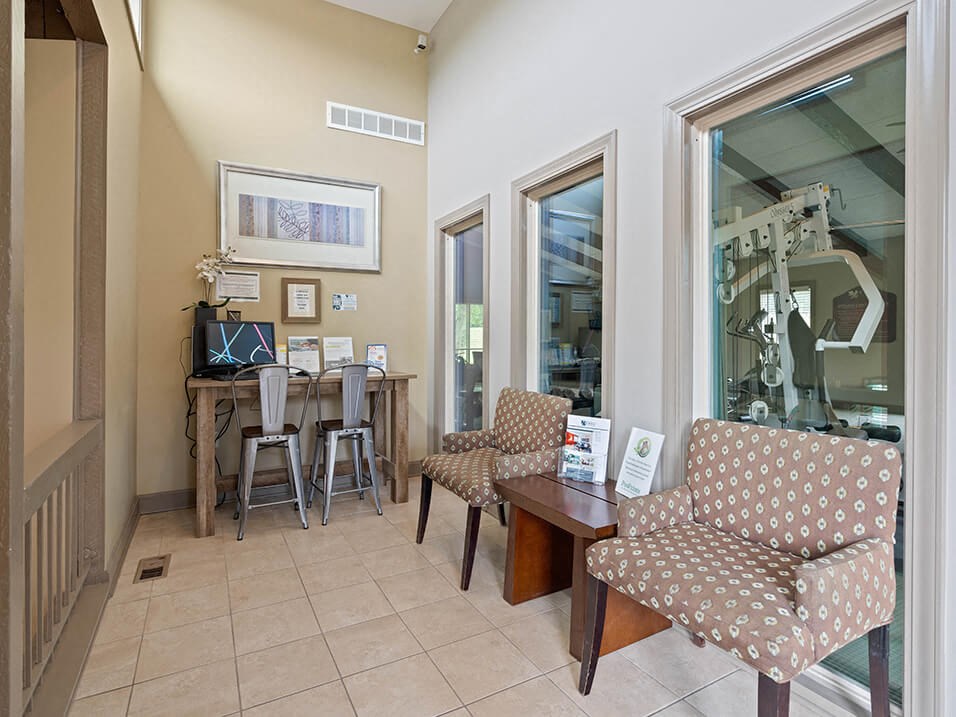 a dining area with a table and chairs and a staircase