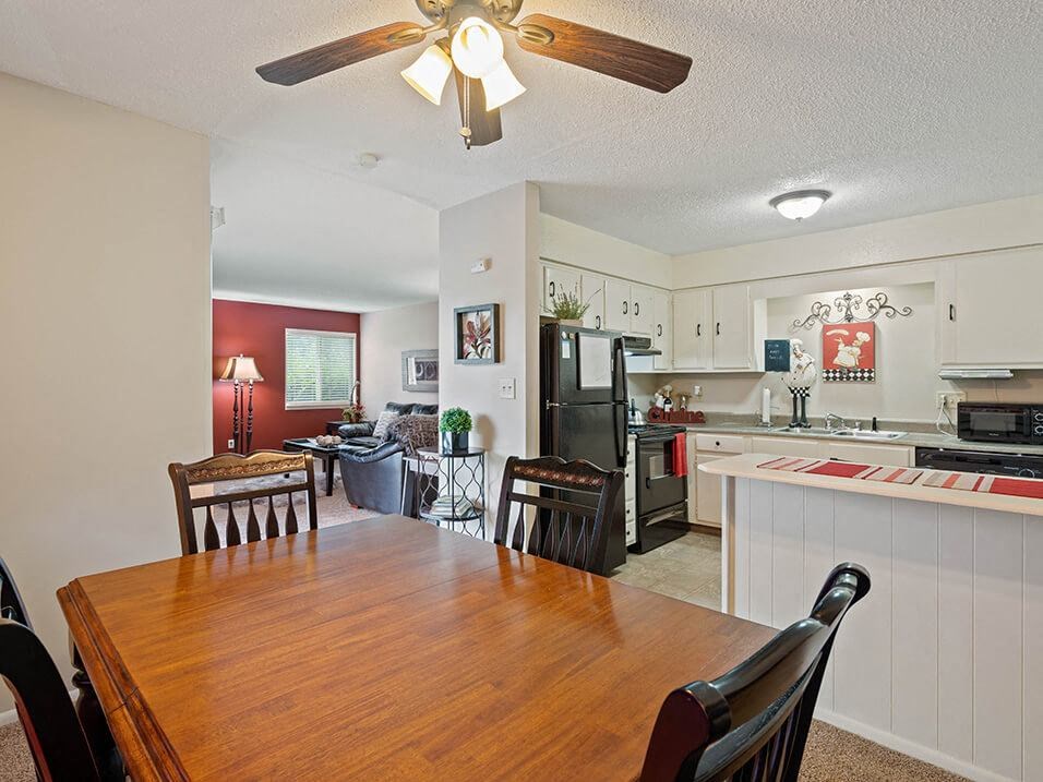 a kitchen and dining room with a wooden table