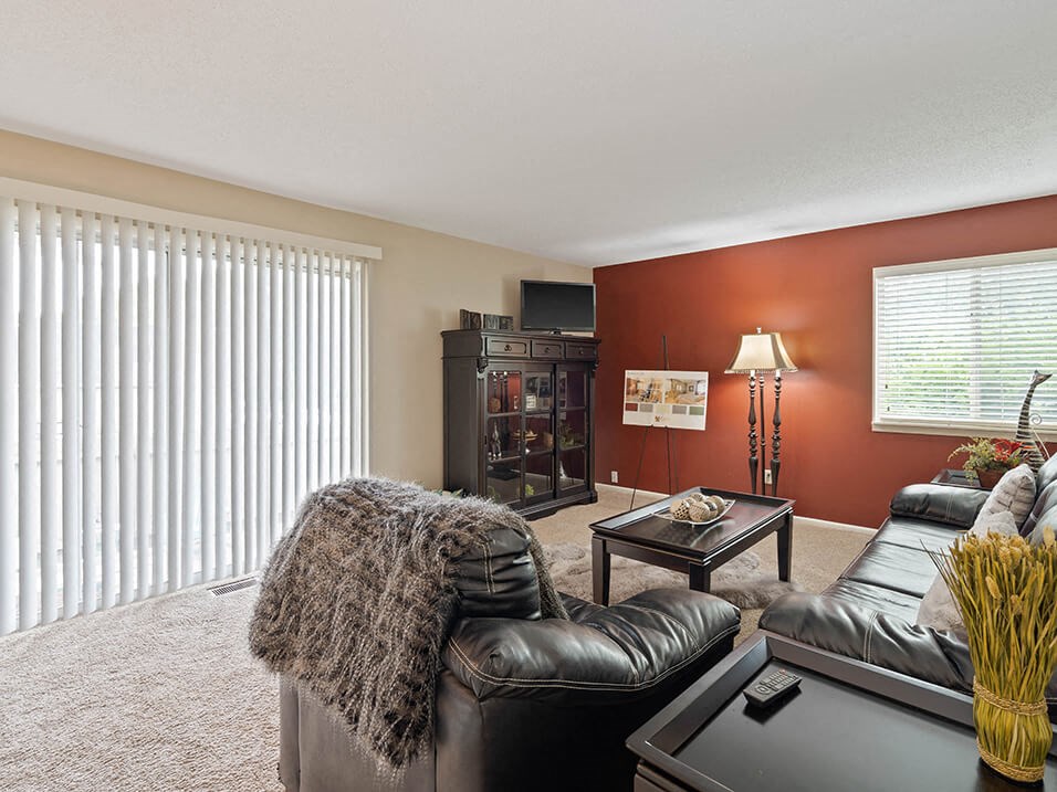 a living room with a leather couch and a table