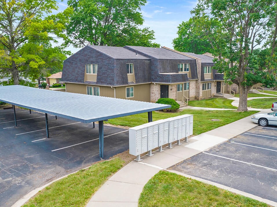a laneway with a blue solar panel in front of some apartments