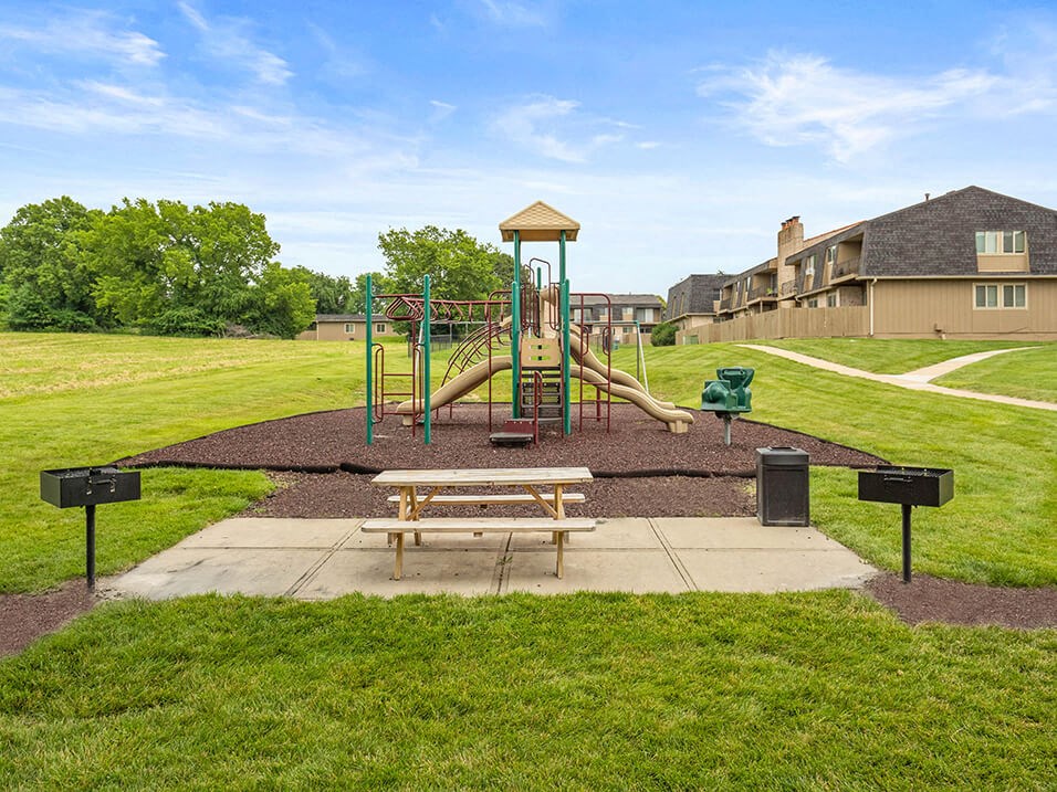a park with a playground and a picnic table