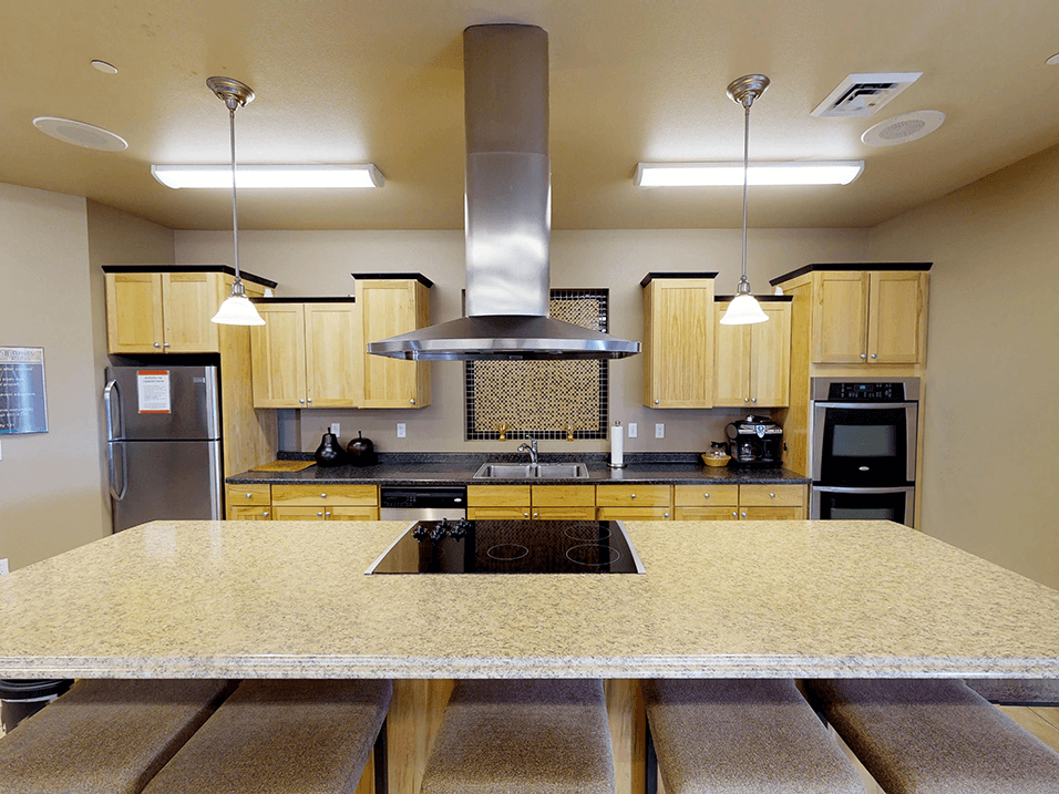 a kitchen with a large island and a stove top oven