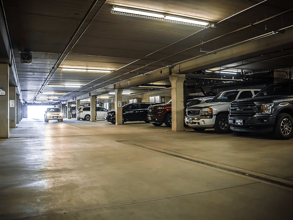 a parking garage filled with cars at apartment complex