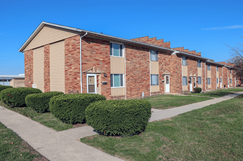 Apartment building with a clear blue sky above.