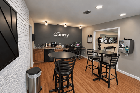 A modern dining area with a black table and chairs.
