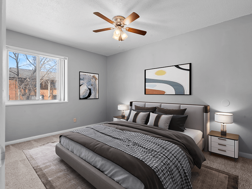 a bedroom with a large bed and a ceiling fan