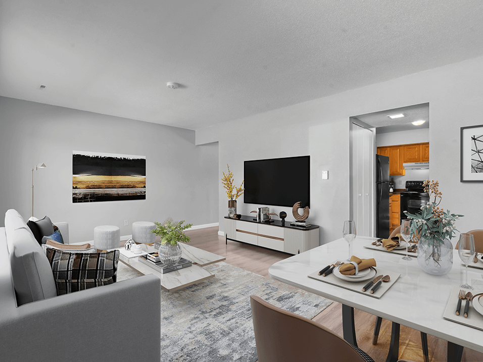 a living and dining area with a white table and chairs and a flat screen tv on the