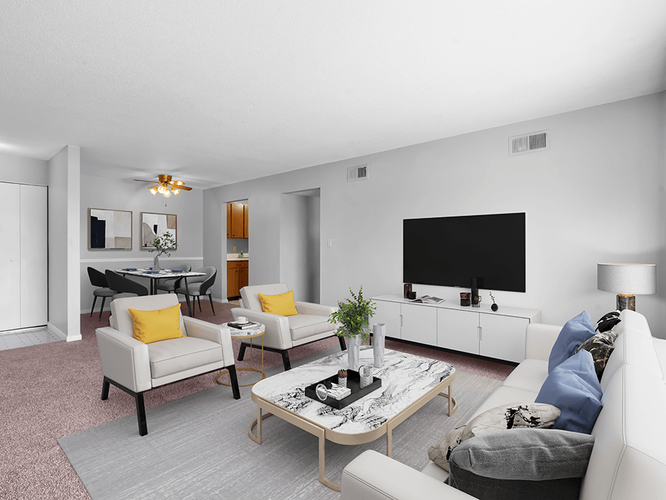 a living room with white couches and chairs and a large tv on the wall