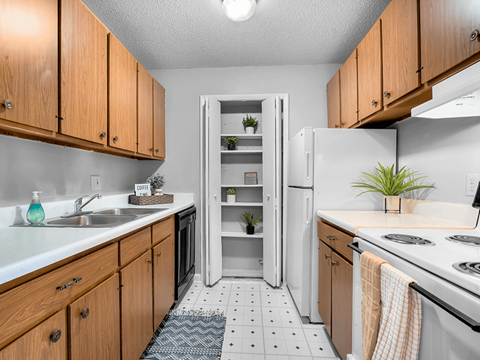a kitchen with white appliances and wooden cabinets
