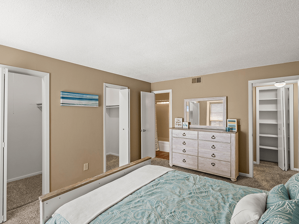 a bedroom with a bed and a dresser