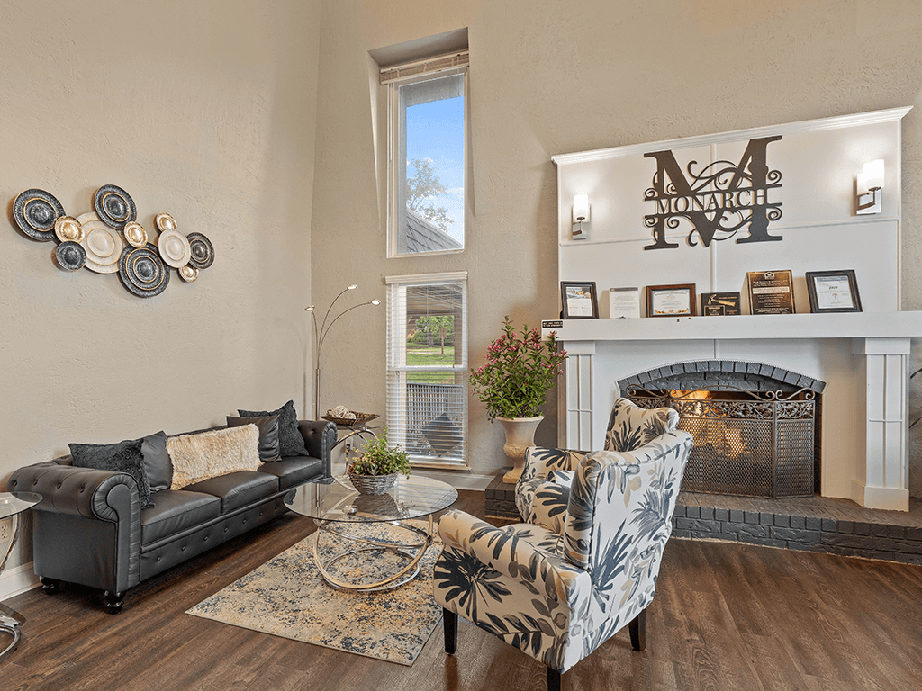 a living room with couches and chairs and a fireplace