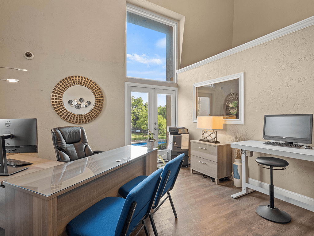 a home office with a desk and a window