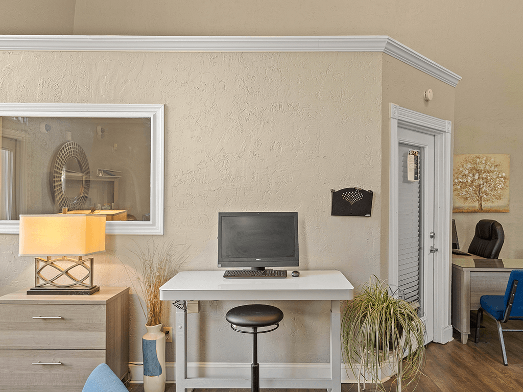 a home office with a computer on a desk