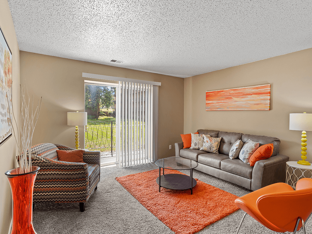 a living room with a couch and a chair and a table
