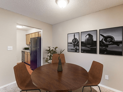 a dining room with a table and chairs and a kitchen