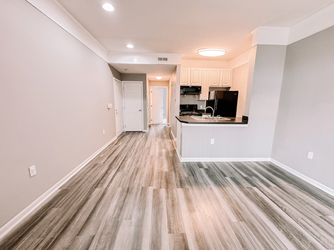 an empty living room and kitchen in a new home