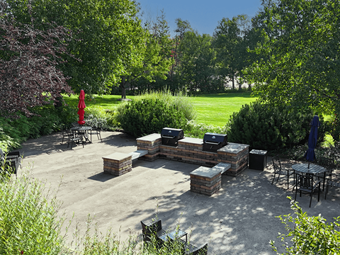 A backyard patio with a fire pit and seating area.
