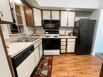 apartment kitchen with oven, dishwasher, and microwave - Photo Gallery 2