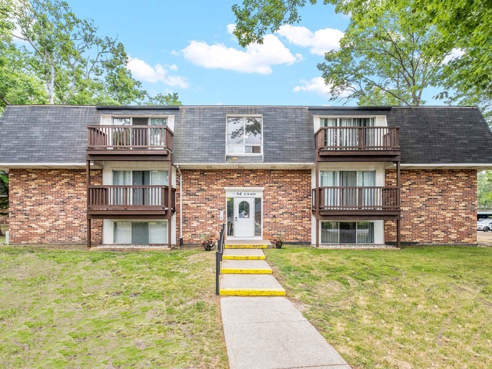a brick apartment building with wooden balconies