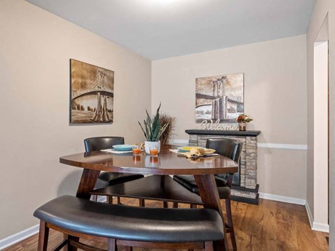a dining room with a table and chairs in front of a fireplace