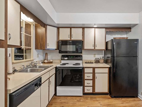 a kitchen with black appliances and white cabinets