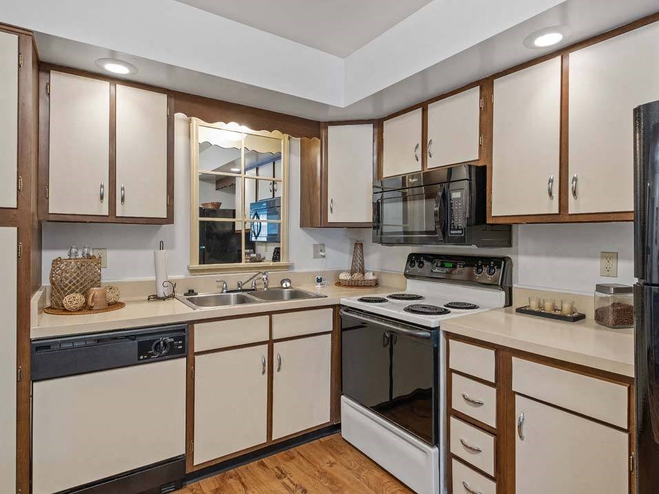 a kitchen with a stove top oven next to a sink