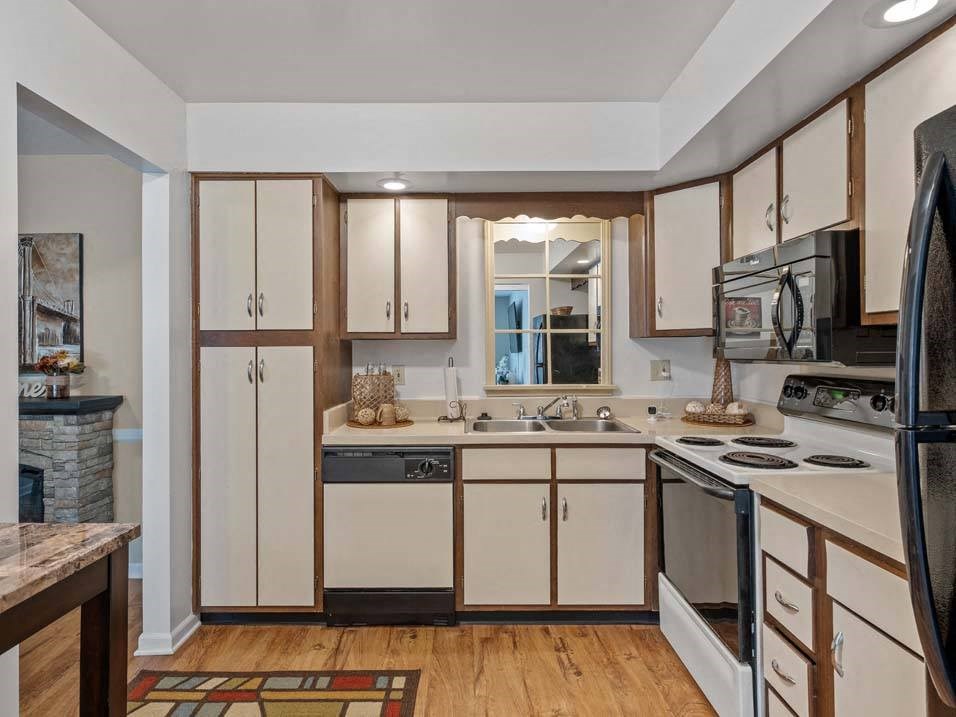a kitchen with a stove top oven next to a sink