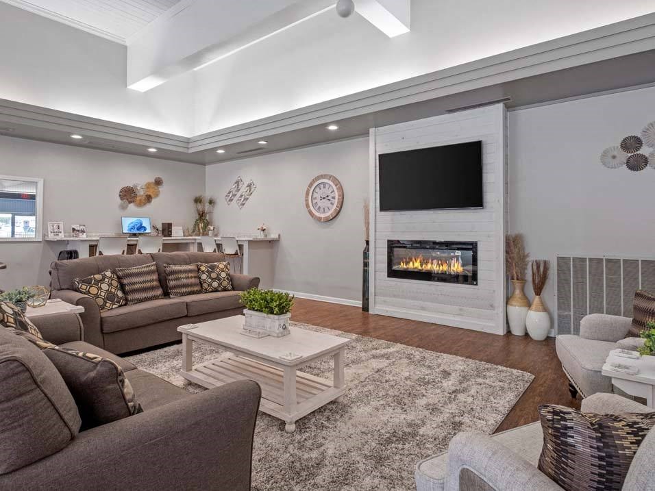 a living room with couches a coffee table and a fireplace