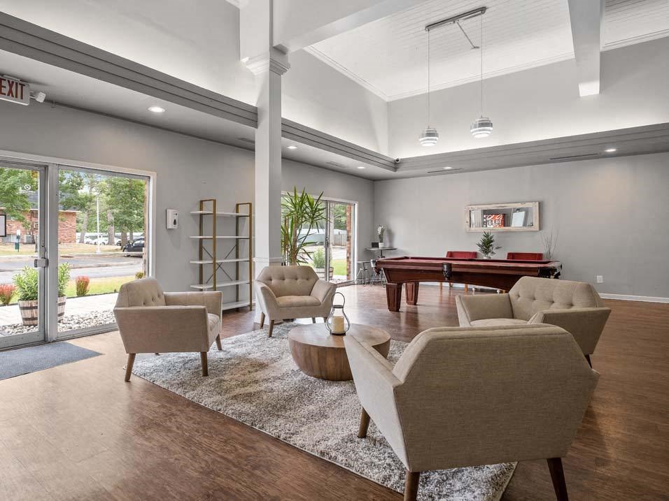 a living room filled with furniture and a pool table