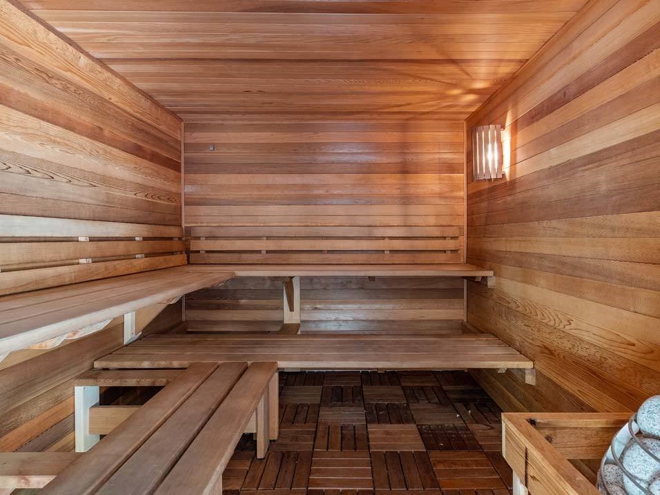 a wooden sauna with benches on the floor