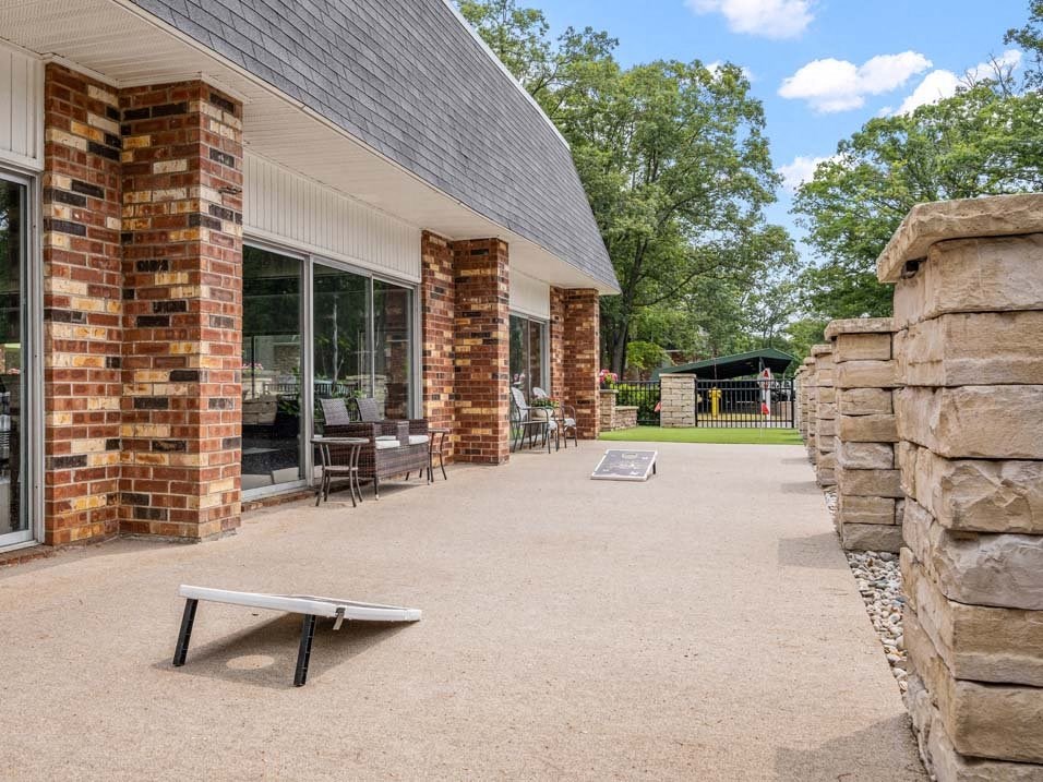 a patio with a bench in front of a building