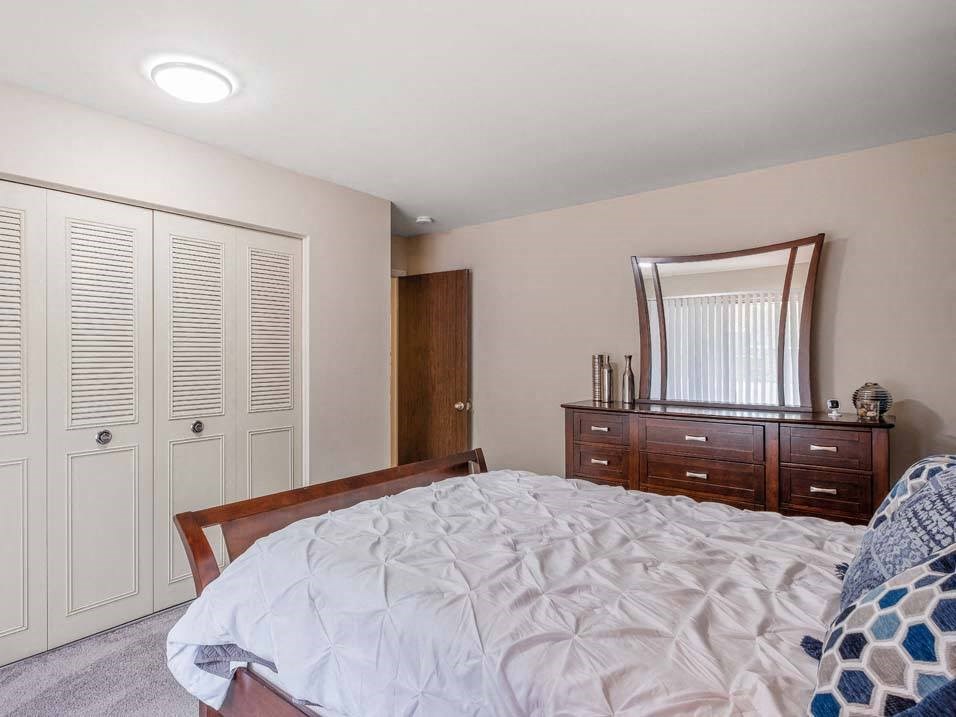 a bedroom with a bed and a dresser