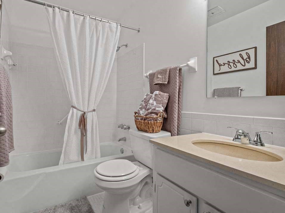 a bathroom with a sink toilet and bathtub