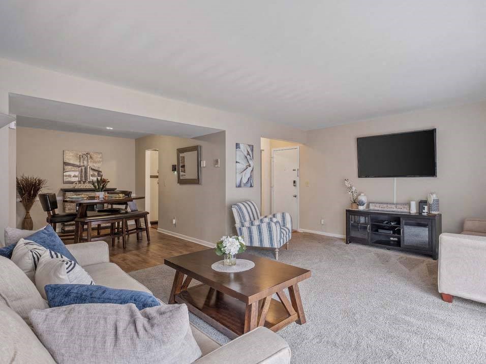 a living room with a couch and a coffee table in front of a tv