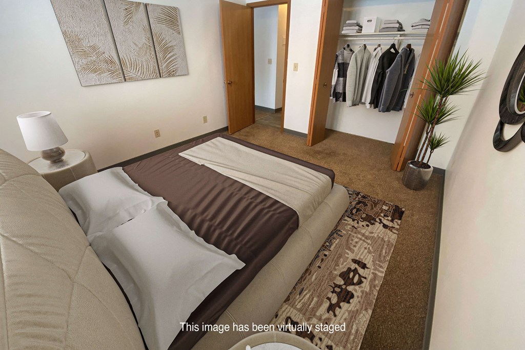 a bedroom with a large bed and a walk in closet