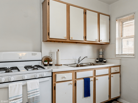a kitchen with white appliances and wooden cabinets