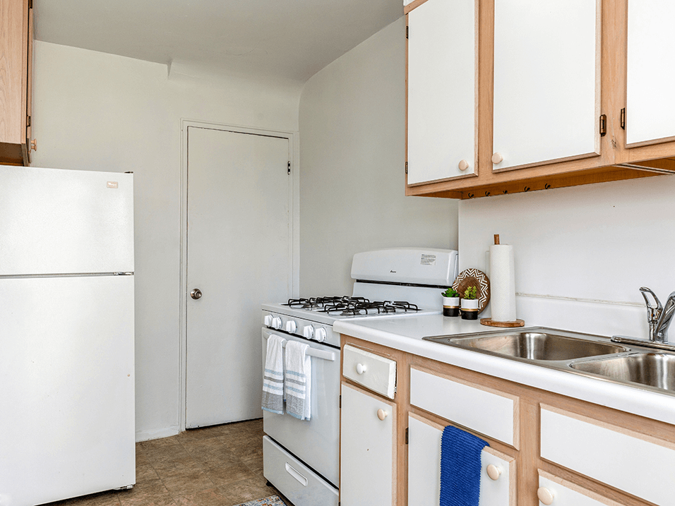 apartment kitchen with refrigerator and oven