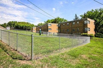 a chain link fence in front of a building