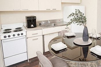 a kitchen and dining room with a glass table
