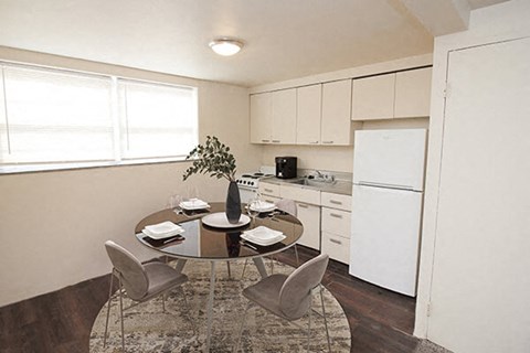 a kitchen and dining room with a table and chairs