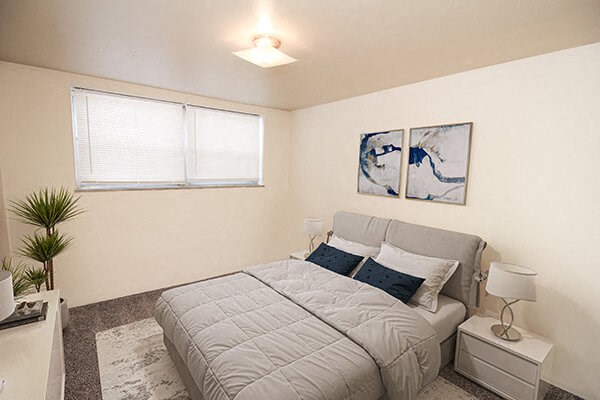 a bedroom with a bed and two night stands