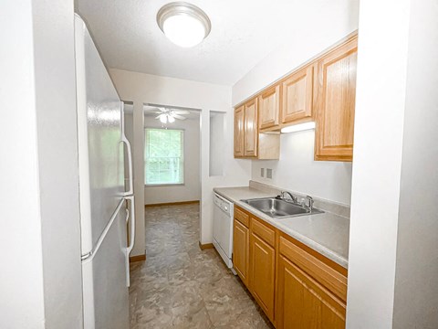 a kitchen with a sink and a refrigerator