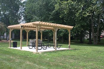 a pavilion with benches and a picnic table at village quarter apartments