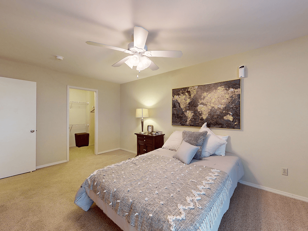 a bedroom with a ceiling fan