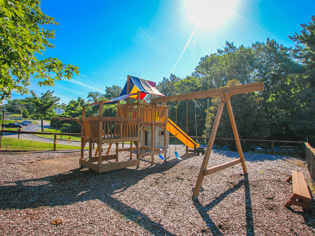 Playground with swing at Village Royale Apartments